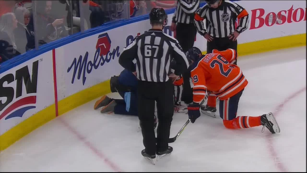Leon Draisaitl hits the ref in the face with the puck while trying to clear the zone.