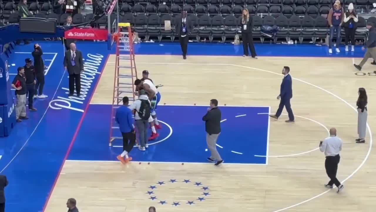 dem389] Wells Fargo center crew working on rims after the game and Giannis  pushes down ladder to practice FTs : r/nba