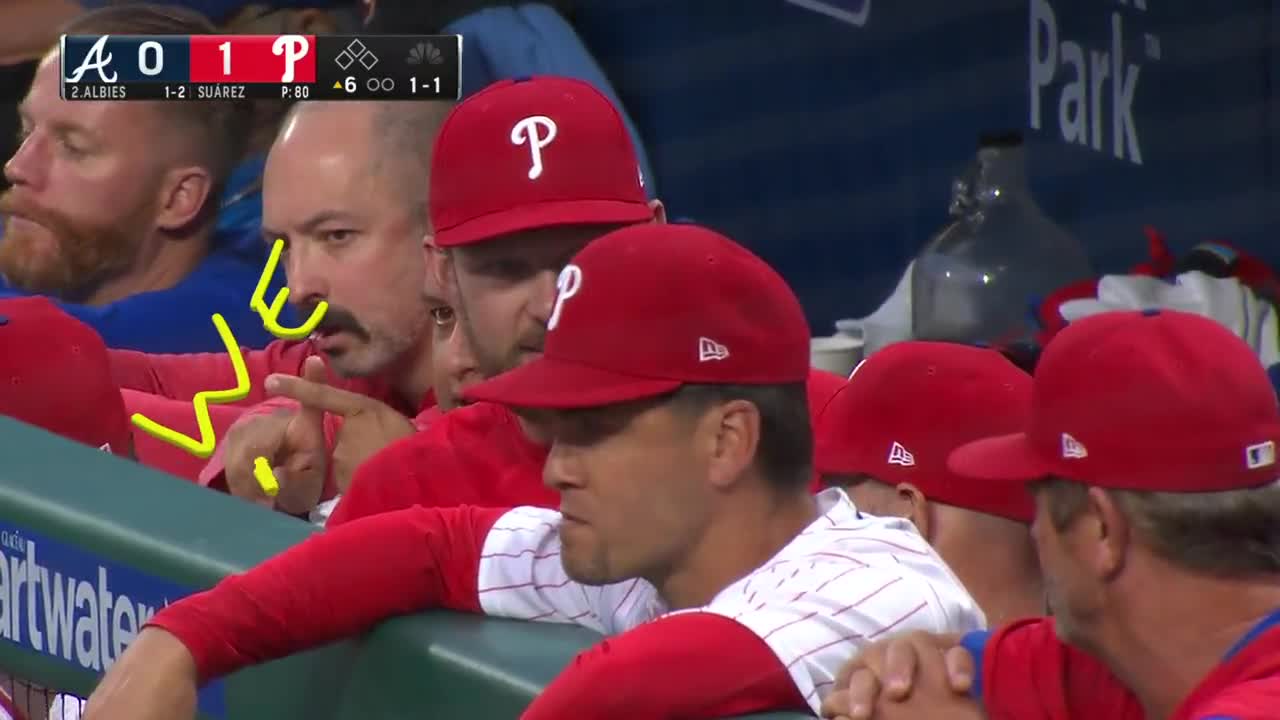 Philadelphia Phillies - J.T. Realmuto, wearing the red pinstripe uniform,  pointing to the dugout after driving in a run.