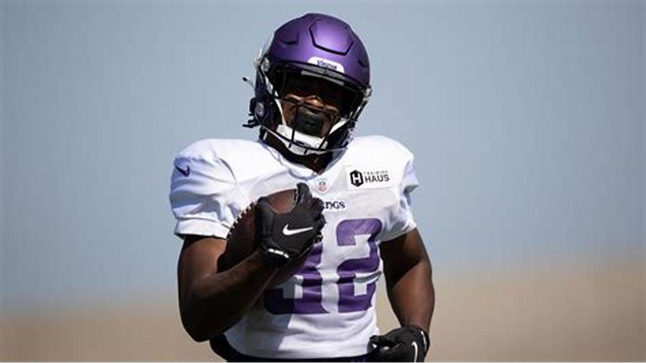 Ty Chandler of the Minnesota Vikings carries the ball against the