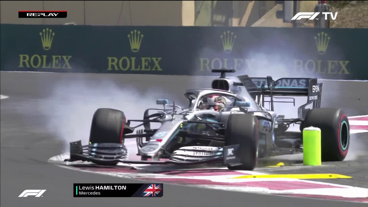 Hamilton loses the car, locks up and knocks over a bollard